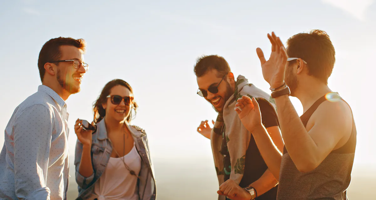 Friends laughing together at sunset