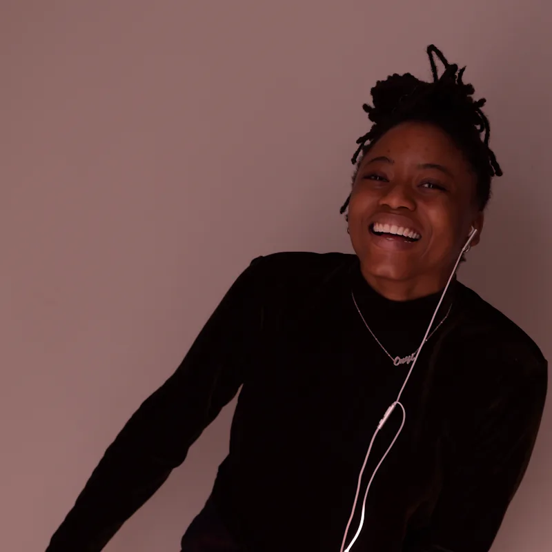 Person laughing while wearing earbuds