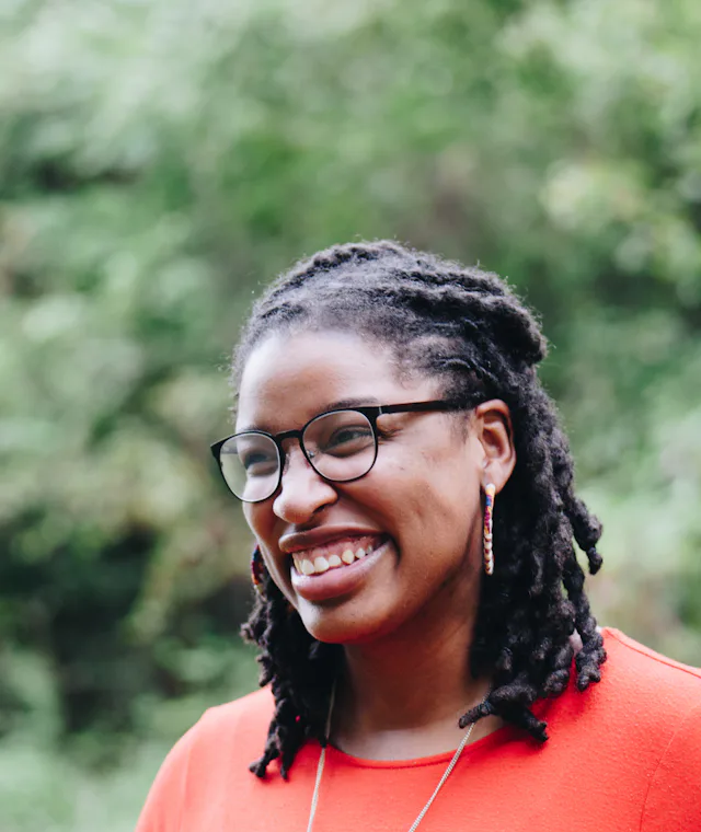 Smiling woman with glasses outdoors