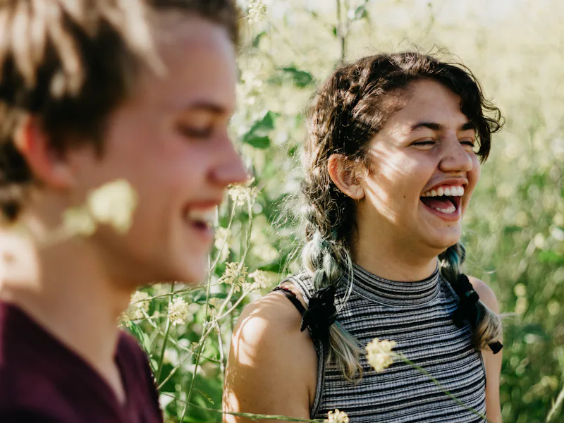 Two friends laughing outdoors